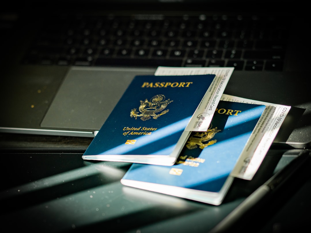 a-passport-sitting-on-top-of-a-computer-keyboard-xxs03-k8yc0.jpeg