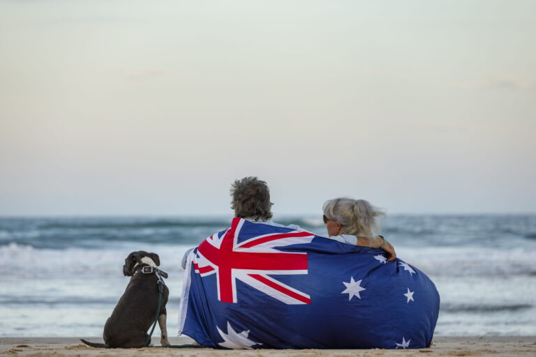 beautiful-shot-couple-beach-with-blue-english-stafford-dog (1)