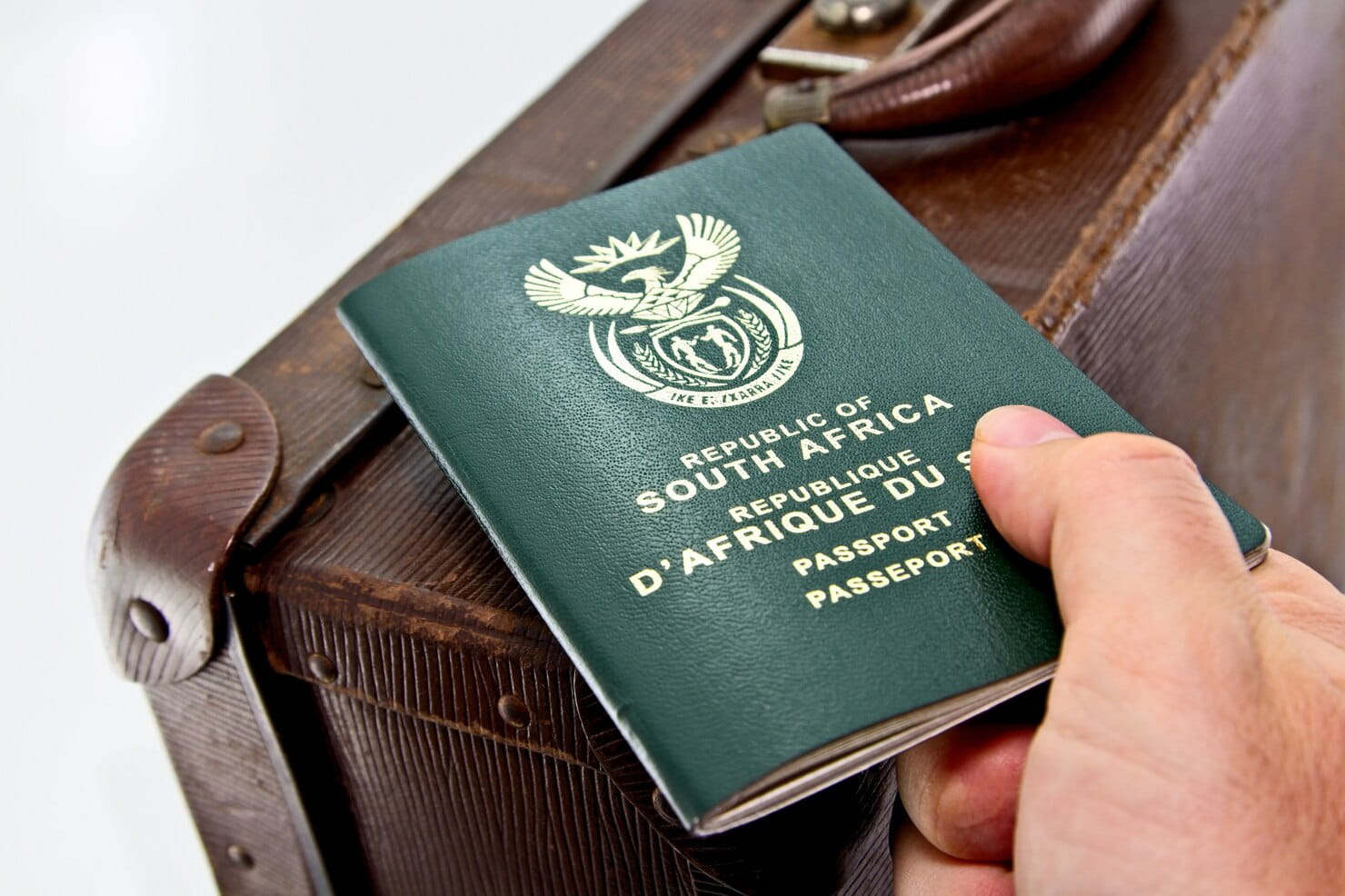 man-holding-african-passport-brown-luggage_181624-8804 (1)