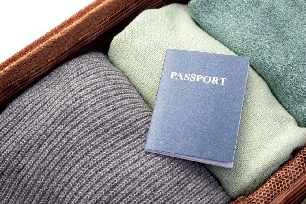 opened-luggage-with-folded-clothes-passport_23-2148927438-1 (1)