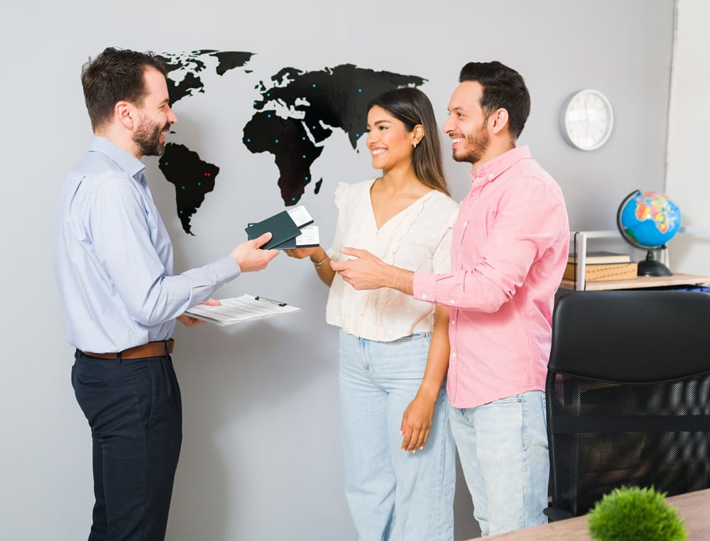 you-are-all-set-your-vacations-sales-representative-giving-passports-plane-tickets-young-woman-man-their-holiday-trip-travel-agency (1)